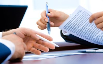 mains tenant stylo et papier sur table de bureau